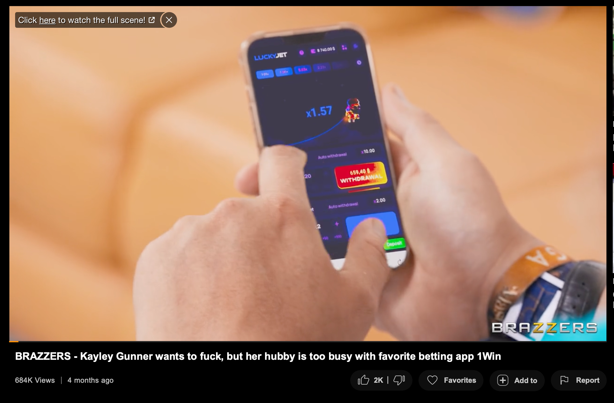 Screenshot from a Brazzers video uploaded to PornHub, showing a gambling app being used.