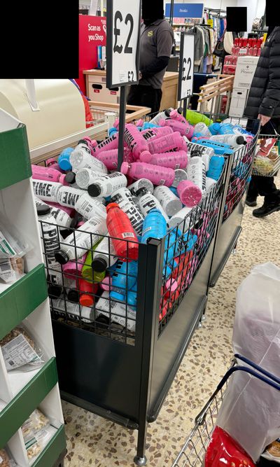 Picture of an overflowing bin containing PRIME Hydration drinks, taken within a Tesco (2023, Internet Talk)